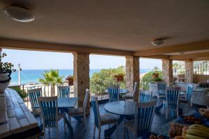 ニコーテラ・マリーナにあるCasa del Soleのテーブルと椅子が備わり、海の景色を望むレストラン