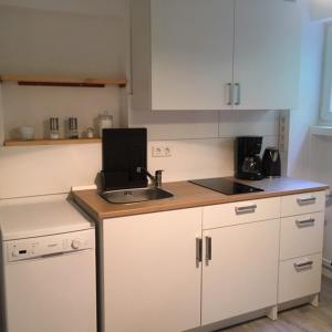 a kitchen with a sink and a counter top at Ferienwohnung (70 qm) mit fantastischem Ausblick in Detmold