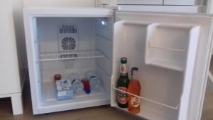 an open refrigerator with drinks and bottles in it at Ca di Ale in Lerici