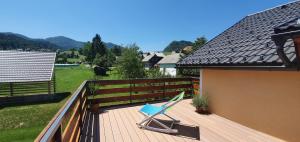 a deck with a chair on top of a house at Tree in Bled