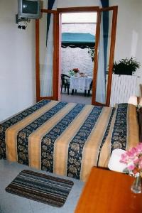 Postel nebo postele na pokoji v ubytování Hotel Greco