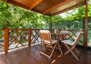 a wooden deck with a table and two chairs at Krk Mobile Homes in Klimno