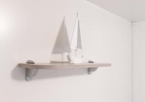 a wooden shelf with a model boat on a wall at Krk Mobile Homes in Klimno