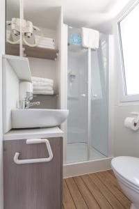 a bathroom with a sink and a shower at Krk Mobile Homes in Klimno