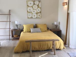 a bedroom with a bed with a yellow bedspread at villa Sant-Anna in Saint-Tropez