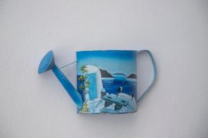 a blue coffee mug with a picture of a plane at Pension Barbara in Katapola