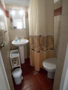 a small bathroom with a sink and a toilet at Pension Barbara in Katapola