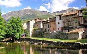 a group of buildings next to a body of water at Luna in Hervás