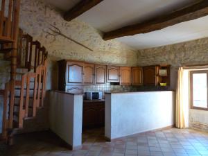 a kitchen with wooden cabinets and a counter top at Les Esclots , Nîmes, Gîtes 4 personne in Générac +4 photos