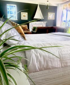 a bedroom with a white bed with a green wall at The Lake House Retreat in Keith