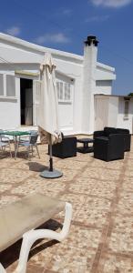a patio with a table and an umbrella in front of a house at Son Roqueta in Palma de Mallorca
