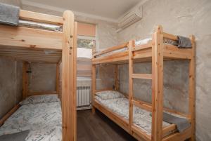 a bedroom with two bunk beds in a room at Hostel Manjari in Sochi