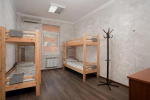 a room with two bunk beds and a desk at Hostel Manjari in Sochi
