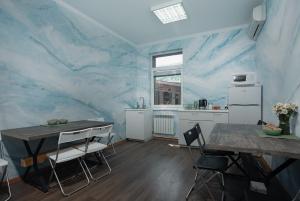 a kitchen with a blue marble wall at Hostel Manjari in Sochi