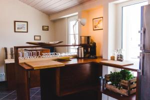 a kitchen with a wooden counter top in a room at Torrinha House in Lagos