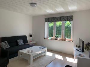 a living room with a couch and a table at B&B Apartment Rødekro in Rødekro