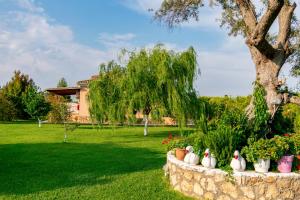a stone wall with four rubber ducks in a yard at Evaggelia Studios in Lefkada Town
