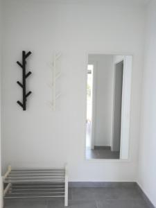 a mirror in a white room with a cross on the wall at Villa Adagio Apartments in Sumartin