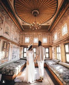 a bride and groom standing in a room with beds at Henna Hotel-Adults Only in Göreme