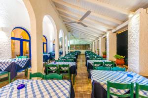 a dining room with blue and white tables and chairs at Hotel Elena Syvota in Syvota