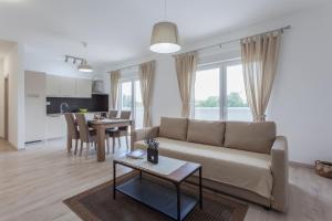 a living room with a couch and a table at Atena Zaton 2 in Nin
