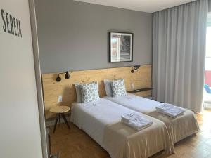 a bedroom with two beds with towels on them at Casa dos Carvalhos in Coimbra +102 photos
