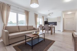 a living room with a couch and a table at Atena Zaton 2 in Nin