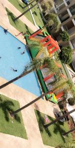 Luxury Apartement Near the Beach في Sidi Bouqnadel: اطلالة علوية على حديقة مائية بها نخيل