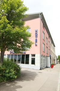 a building with a sign on the side of it at Hotel-Restaurant Pfeffermühle Balingen in Balingen