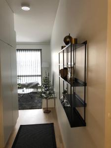 a room with a black book shelf with a plant at Beautiful apartment at Toppilansalmi in Oulu