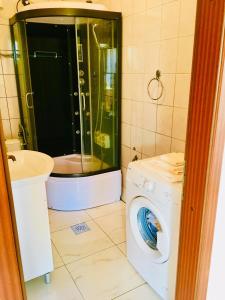 a bathroom with a washing machine and a sink at Apartmani Nina in Šibenik