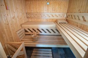 a wooden sauna with a bench in the middle at Anavasi Mountain Resort in Pramanta
