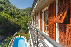 a balcony of a house with a swimming pool at A Casa di Mila in Sori