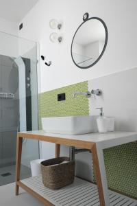 a bathroom with a sink and a mirror at INVENTO bnb unconventional maison in Civitanova Marche