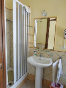 a bathroom with a sink and a mirror at Locazione Turistica Le Fate in Agrigento +38 photos