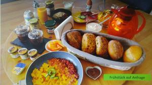 a wooden table with a bunch of food on it at Gästezimmer Carmen in Schwendi