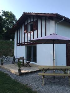 een huis met een picknicktafel en een paraplu bij Camp Basque // Maison Erribera // Bidarray in Bidarray