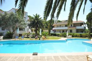 a large swimming pool in front of a building at Niki Hotel Apartments in Ialysos