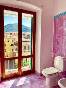 a bathroom with a toilet and a window at PRIONE173 City Center in La Spezia