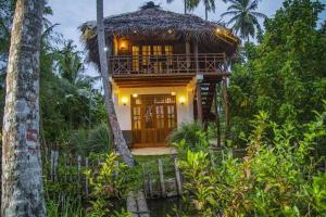 a house in the middle of a forest at Milkyway Holiday Resort in Unawatuna