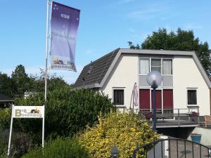 
a house with a sign on the front of it at B&B Bovenweg in Rhenen

