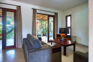 a living room with two couches and a table at Unidades Vilas Triplex no Pipa Beleza in Pipa