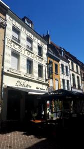 a large white building with a sign on it at Hôtel Restaurant L'Industrie in Saint-Omer