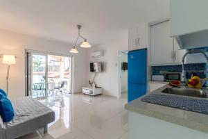 a kitchen and living room with a sink and a counter at Sea View apartment in Pyla