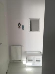 a white room with a radiator and a window at Bolero in Dziwnówek