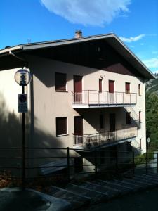 a large white building with a balcony and stairs at Residence ELIOS in Caramanico Terme