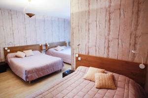 a hotel room with two beds in a room at Entre Mer et Montagne in Digoin