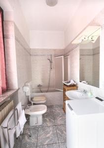 een badkamer met een wastafel, een toilet en een douche bij La Corte in Rescaldina