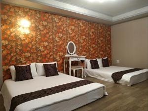 Postel nebo postele na pokoji v ubytování Guan Lun Hotel