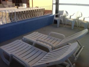 a group of white chairs and tables and chairs at Casa di Jacopo in Lipari